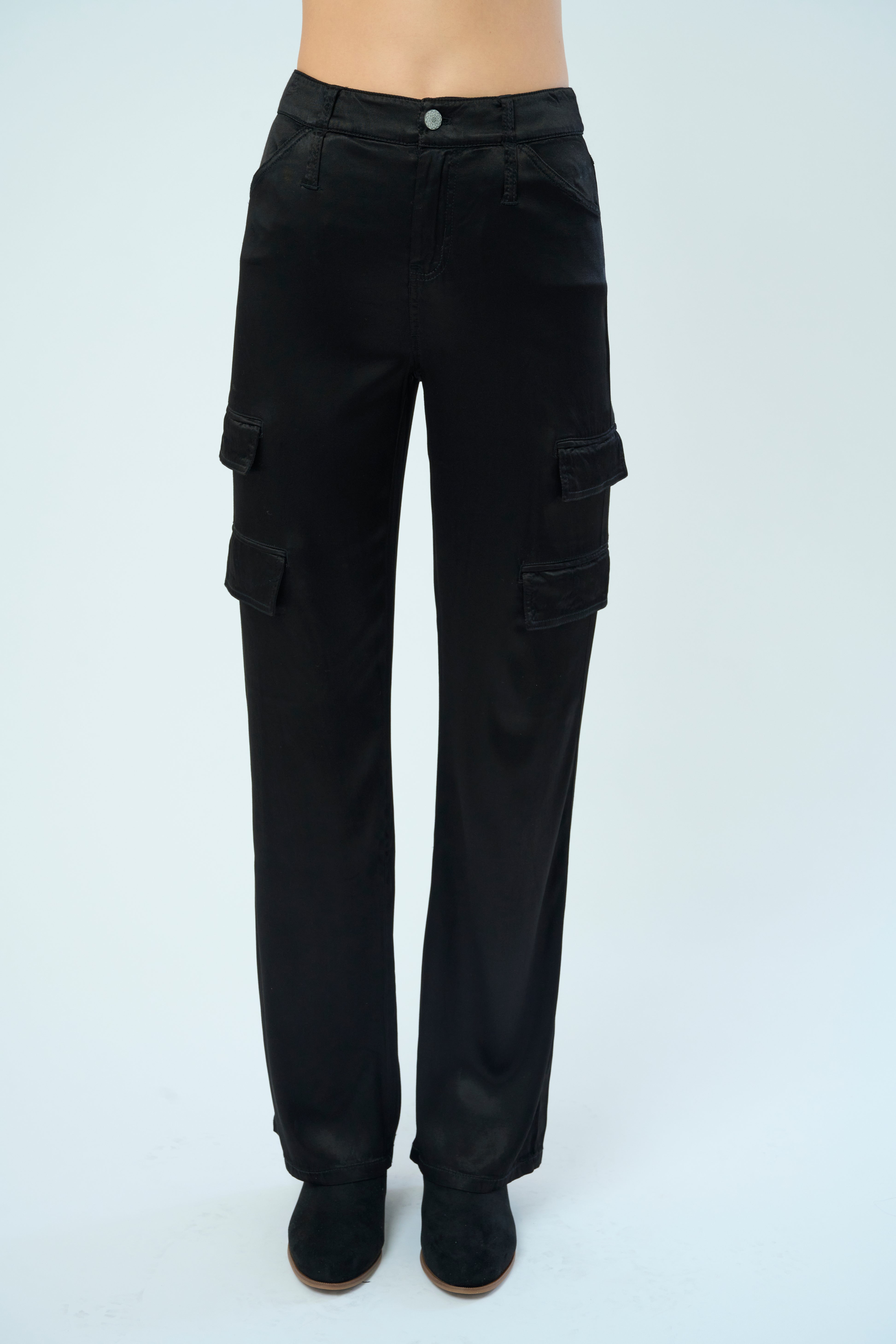 Front view of a tall female model confidently posing wearing our black colored Zendaya Stretch Viscose Satin Wide Leg Pant from Marrakech Clothing.